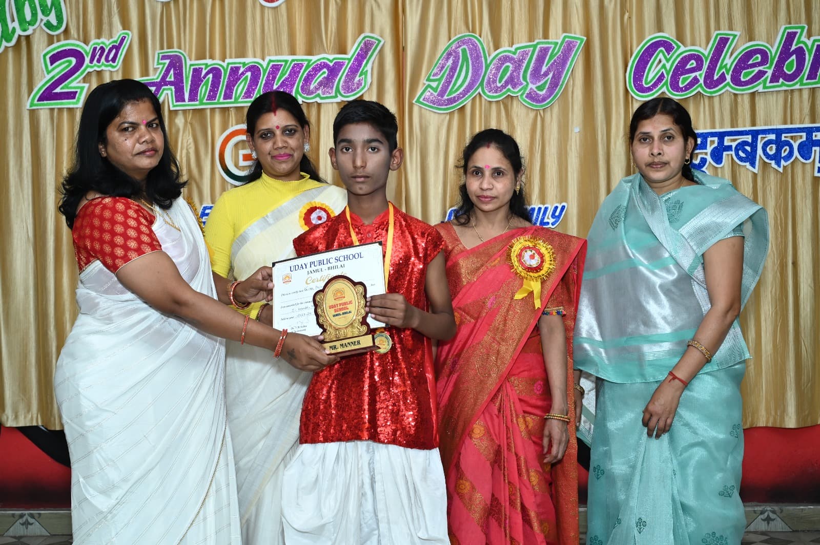 Student receiving an award from teachers