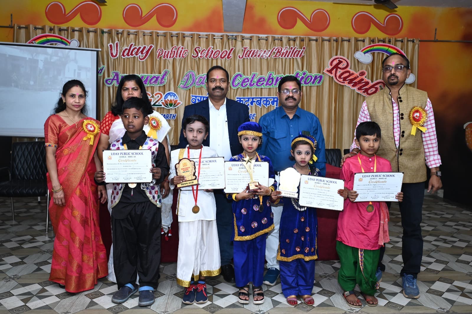 Prize-winning students with trophies and certificates