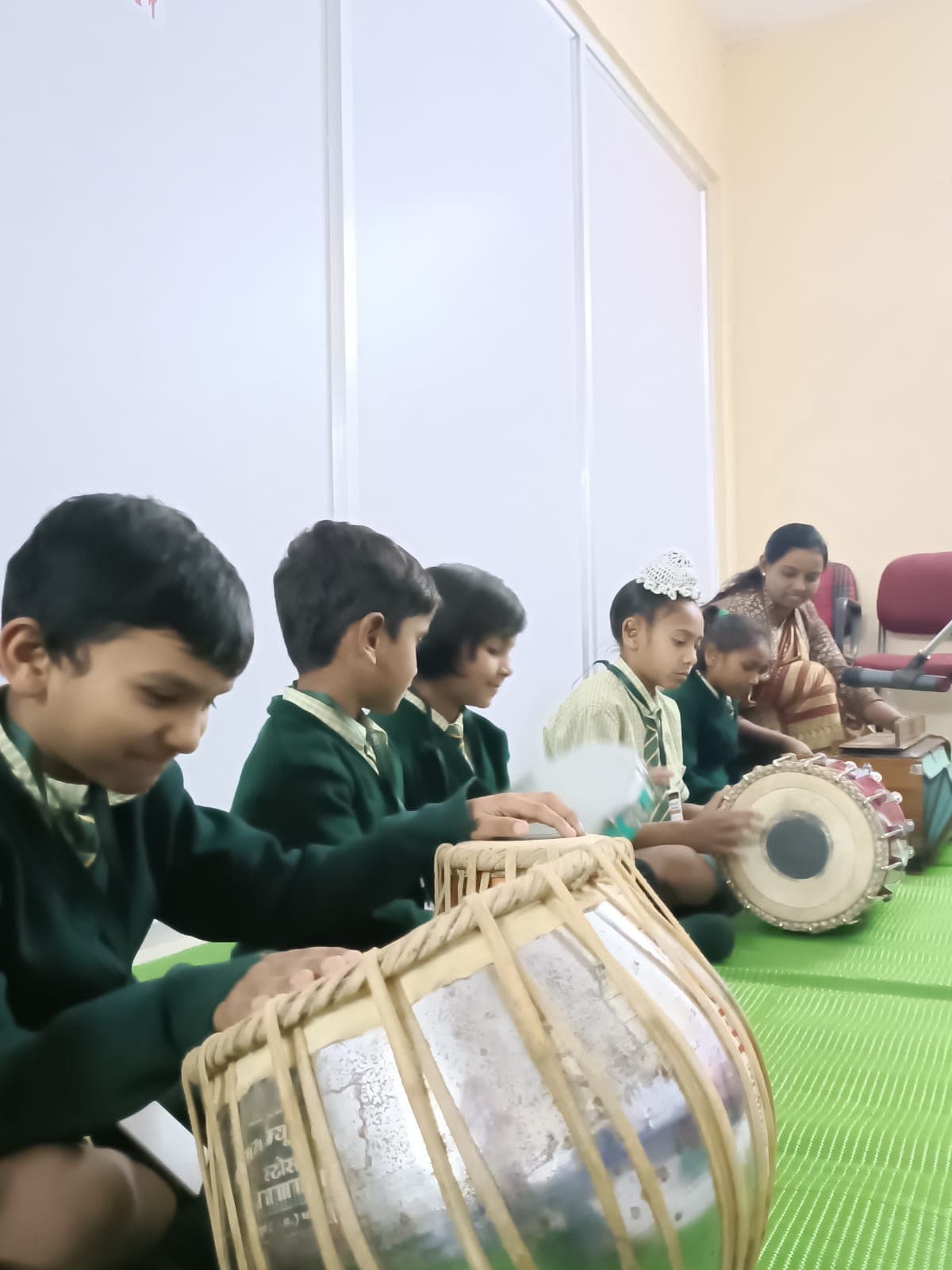Students playing tabla in music class